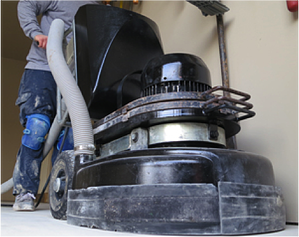 Diamond grinding a garage floor before applying the epoxy coatings.